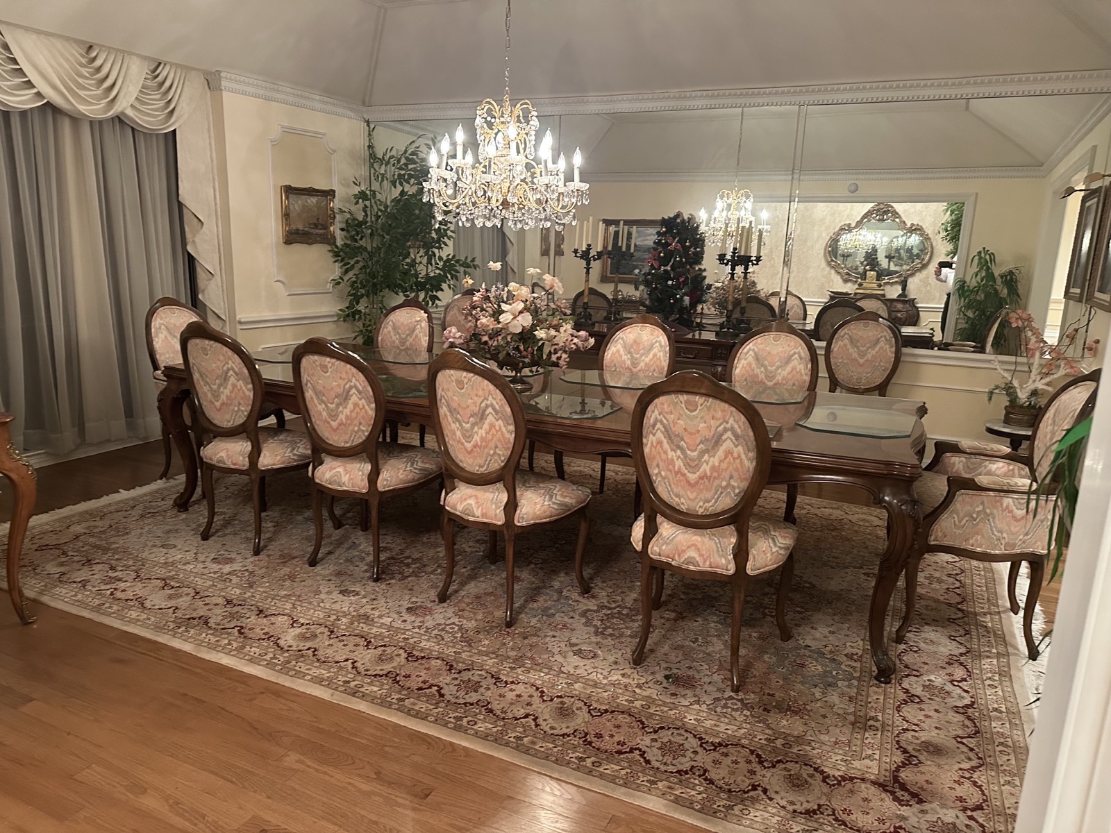 Formal dining room with crystal chandelier and table set for twelve