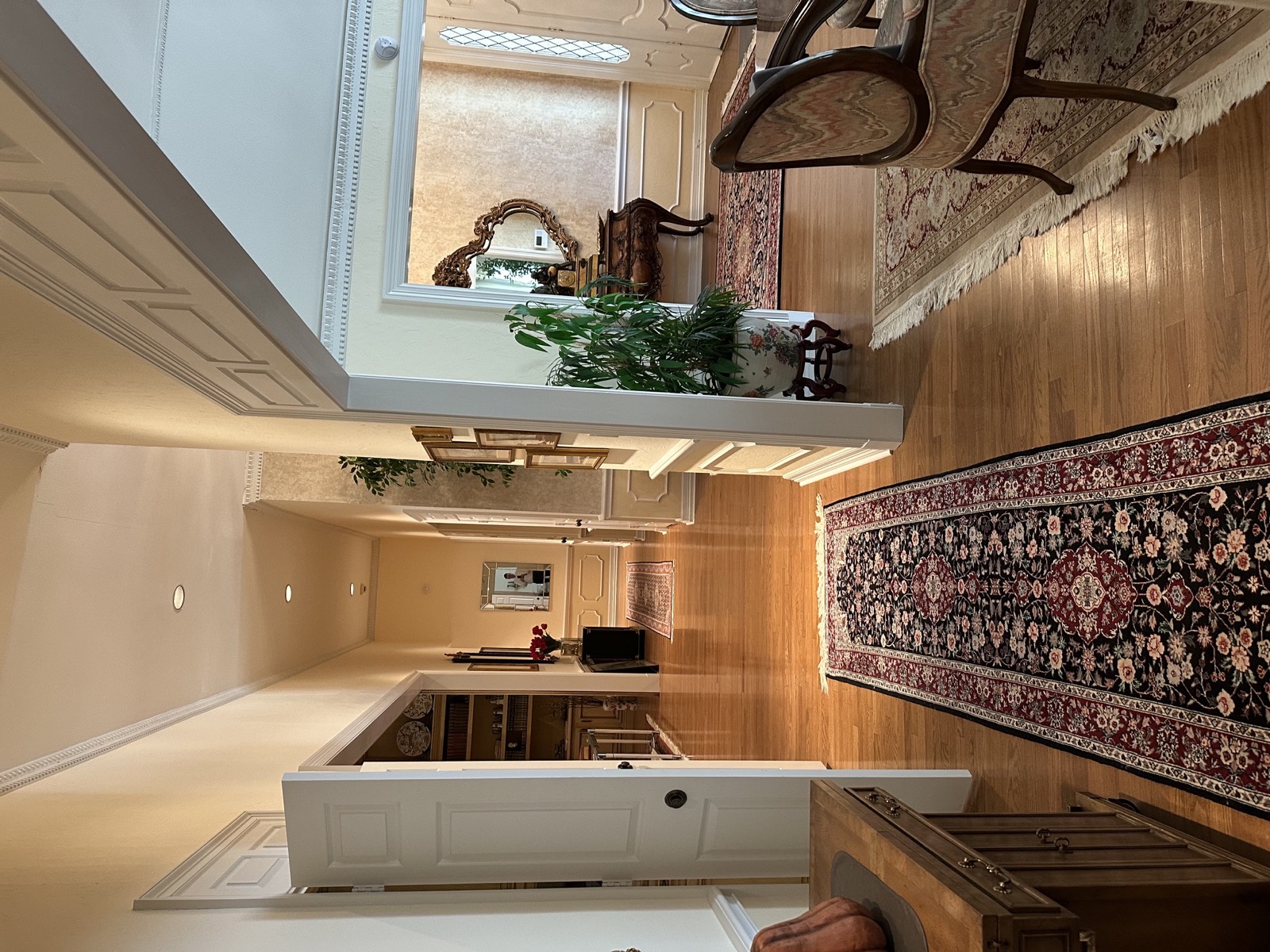 Wide hallway with runner rug leading to the foyer
